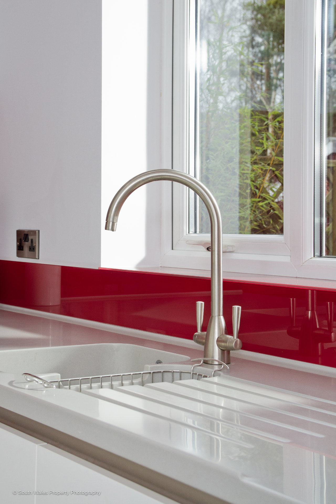 A clean white galley kitchen with German cabinetry - image 04