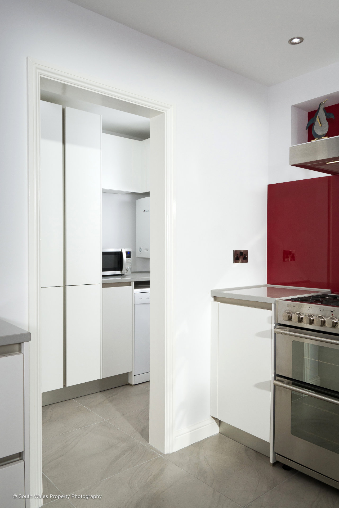 A clean white galley kitchen with German cabinetry - image 05